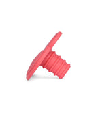 A bright red silicone bottle stopper that is also a children's teether with a ribbed cylindrical body and a flat, flared top, shown on a clean white background.